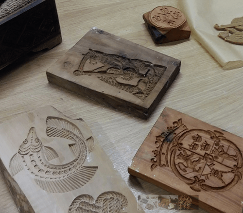 wooden tiles with engraved patterns on the table.